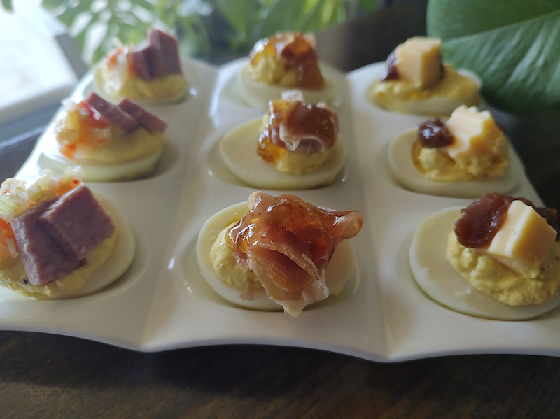 Bye Bye Birdie reimagines a familiar duo with its Charcuterie Deviled Egg Flight. Topped with salami, prosciutto with fig jam, and gouda with apple butter, each egg offers a different take on the classic pairing.
