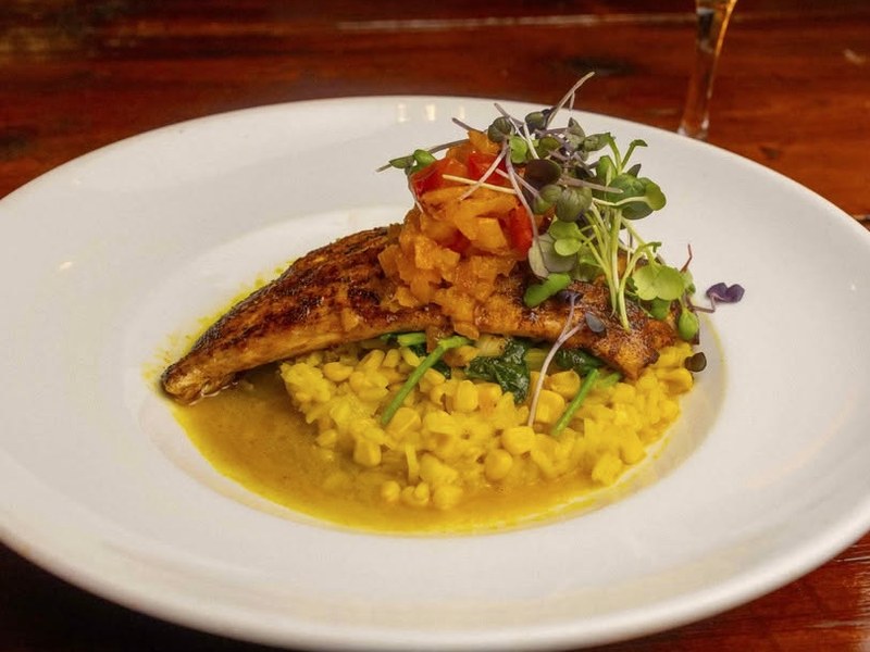 Fish with golden risotto and fresh greens