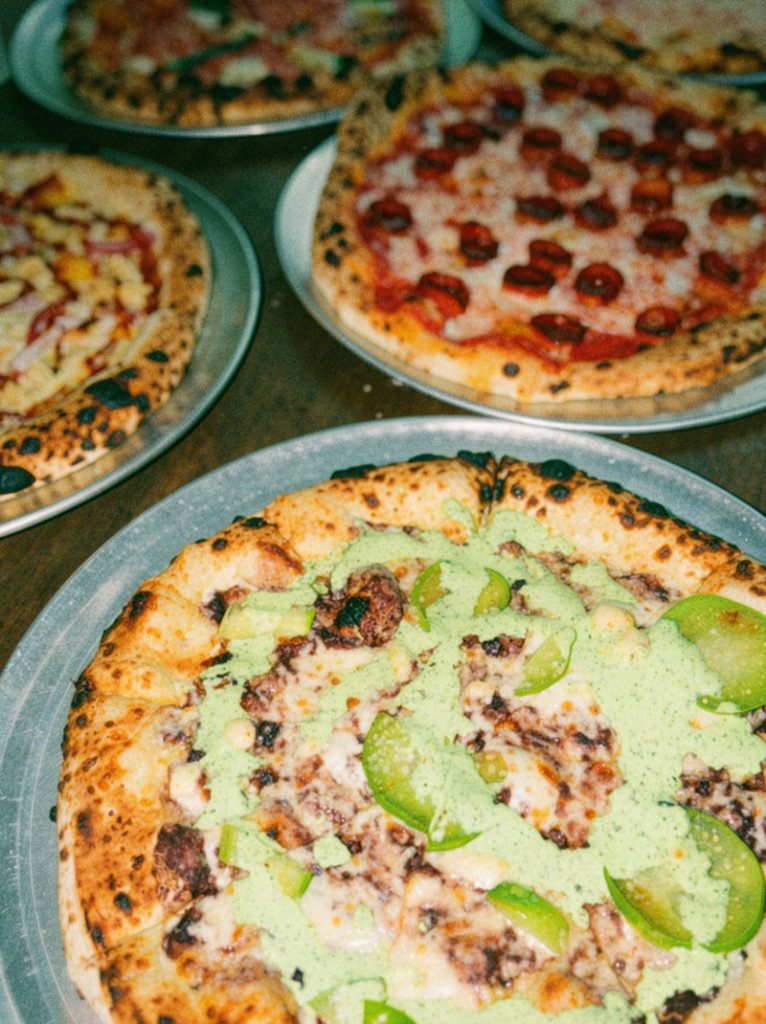 The Southern Peel layers black bean purée, fresh tomatillo and queso fresco onto a pizza finished with jalapeño, cilantro and lime crema