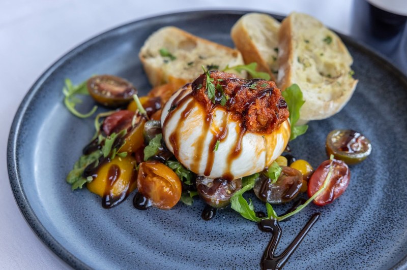 Few things bring a table together faster than burrata. Alexander’s Restaurant & Wine Bar