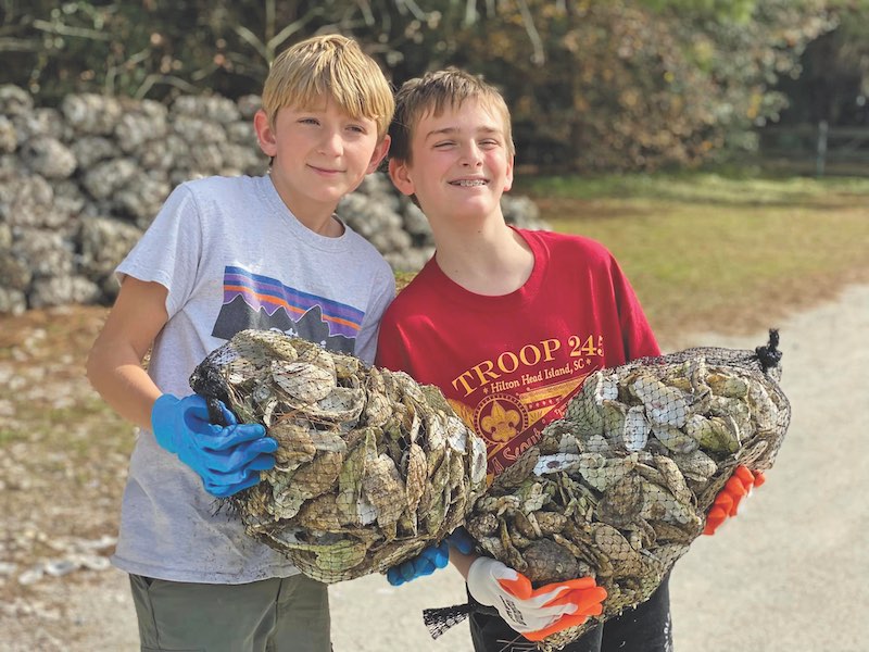 Two kids with oyster shells