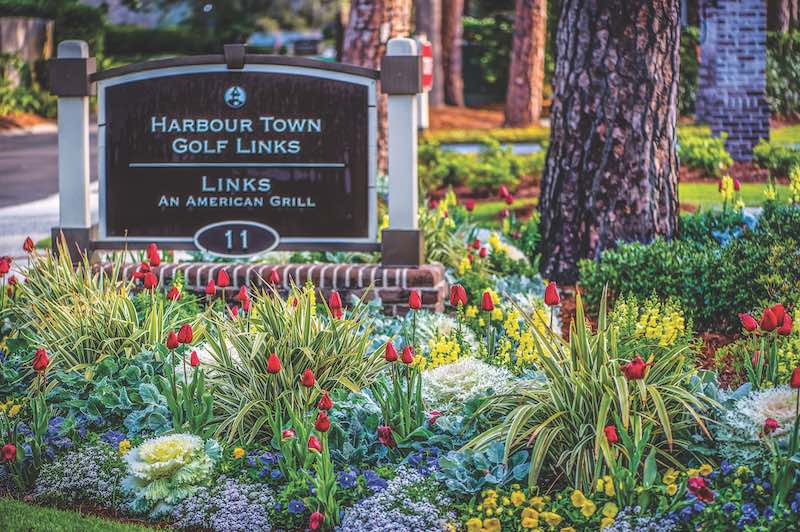 Harbour Town Golf Links Sign surrounded by blooming flowers