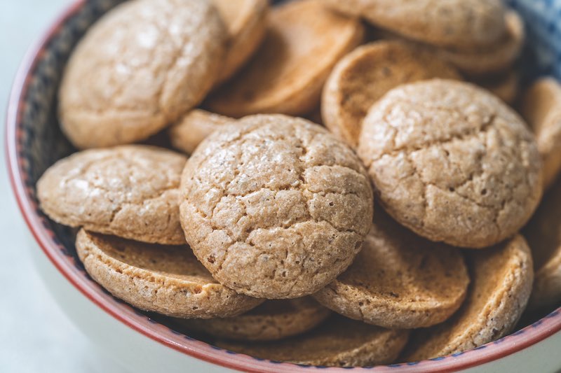 Chewy Soft Italian Amaretti Cookie Biscuits in Ceramic Bowl. Traditional Dessert Snacks.