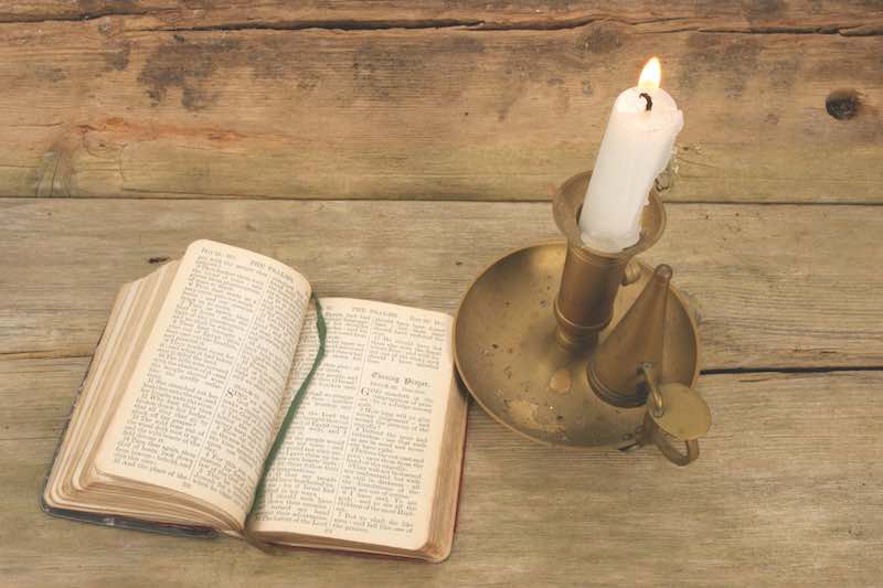 Old prayer book and candle