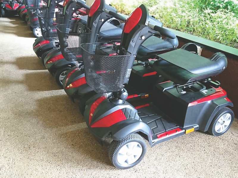 A collection of power mobility scooters with four wheels for the convenience of the elderly.