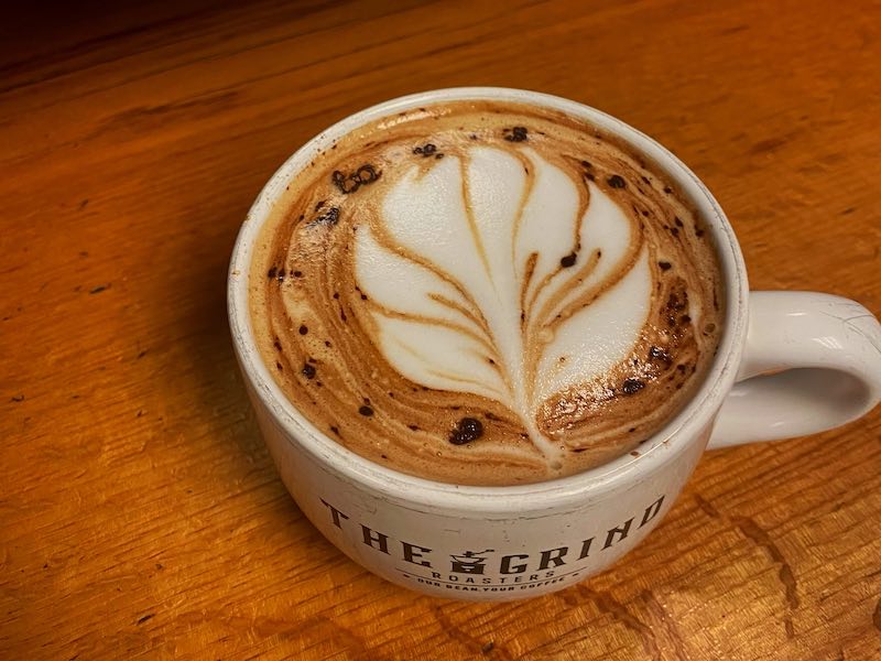 A cup of coffee on a table from The Grind, Bluffton, SC