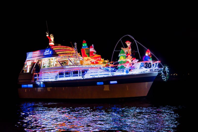 Patchogue, New York- November 21, 2021: A Christmas lights decorated boat with Christmas characters in