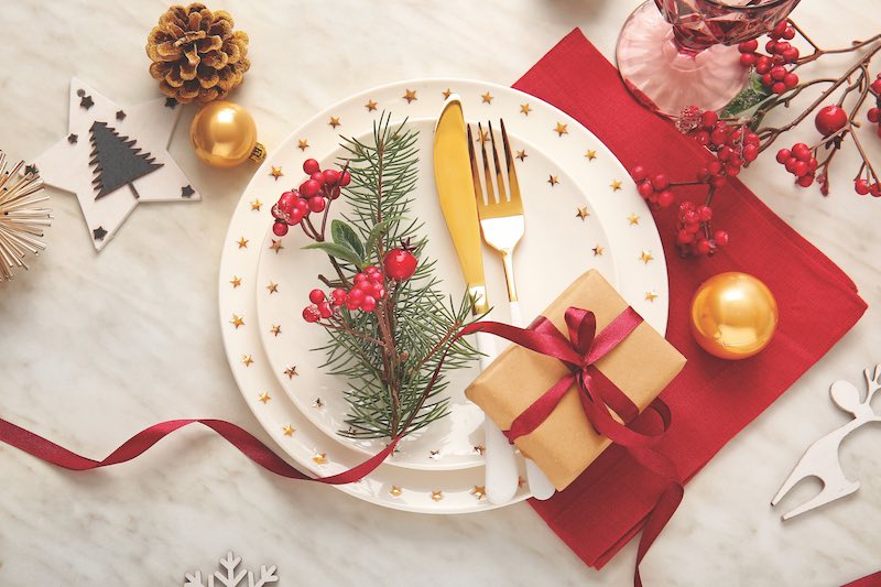 Beautiful Christmas table setting with mistletoe on white background