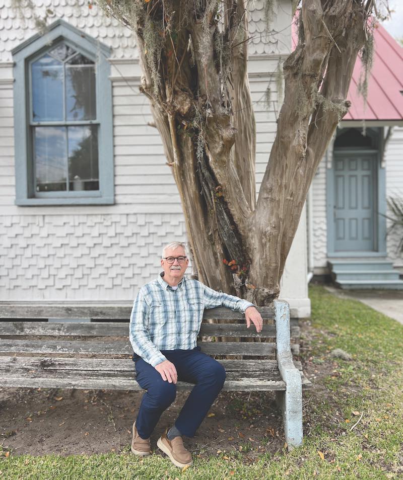 Micheal Murphy in front of the historic Berean Church crape myrtle in Beaufort