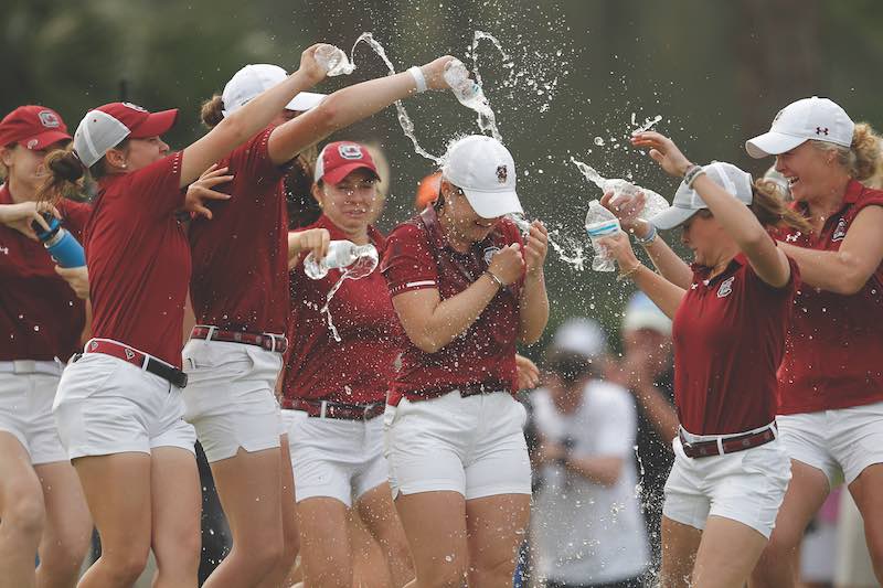 Members of the South Carolina women's golf team celebrate with Mathilde Claisse after she posted the best individual score at the 2023 Darius Rucker Intercollegiate at Long Cove Club on Hilton Head Island