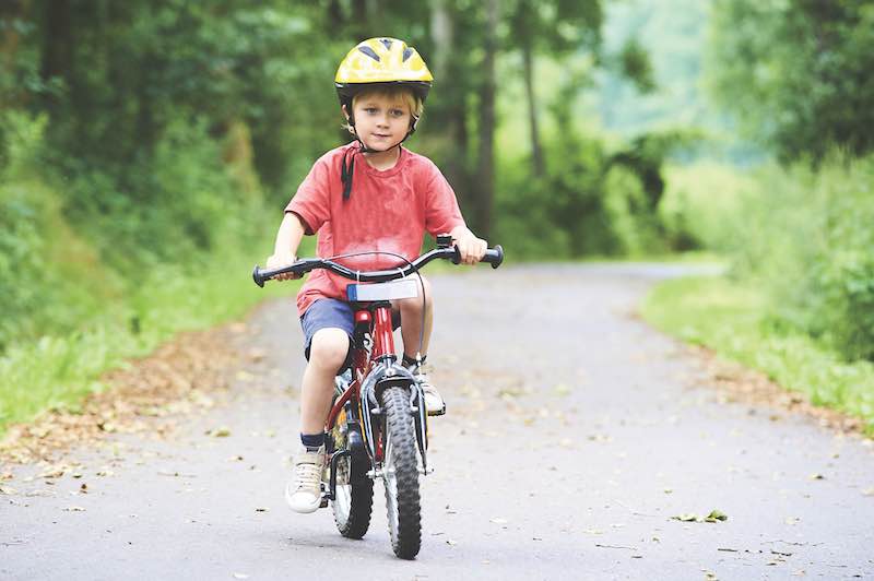 A little boy riding his bike on Arrow Road Bike Path, Hilton Head Island, SC