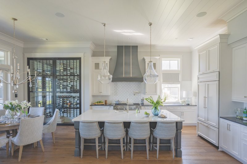 Open Kitchen and Dining room with wine cellar wall