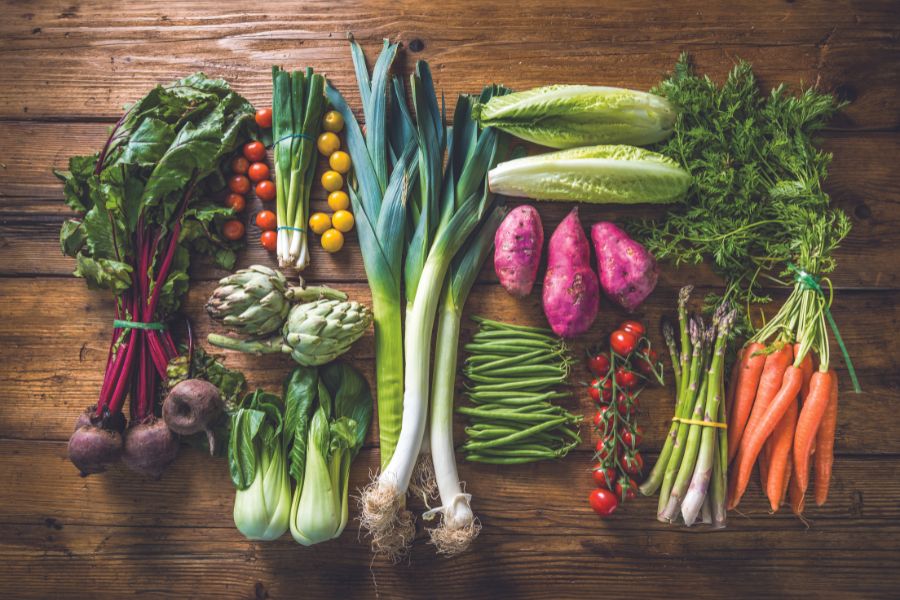 Fresh produce laying on a wooden table - dark theme