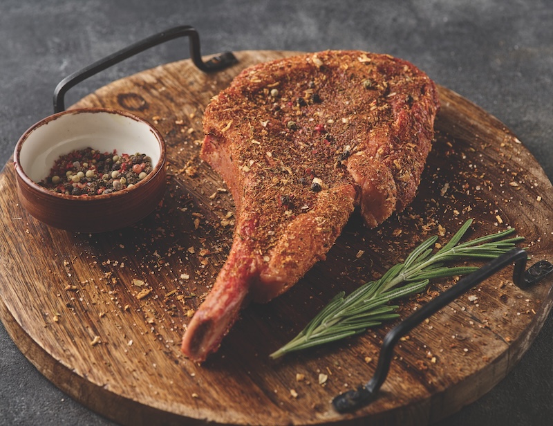 Raw Tomahawk Steak in Rub Marinade for BBQ