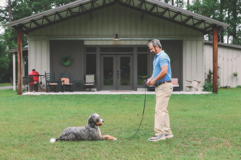 Gentry Thames with his dog in the backyard