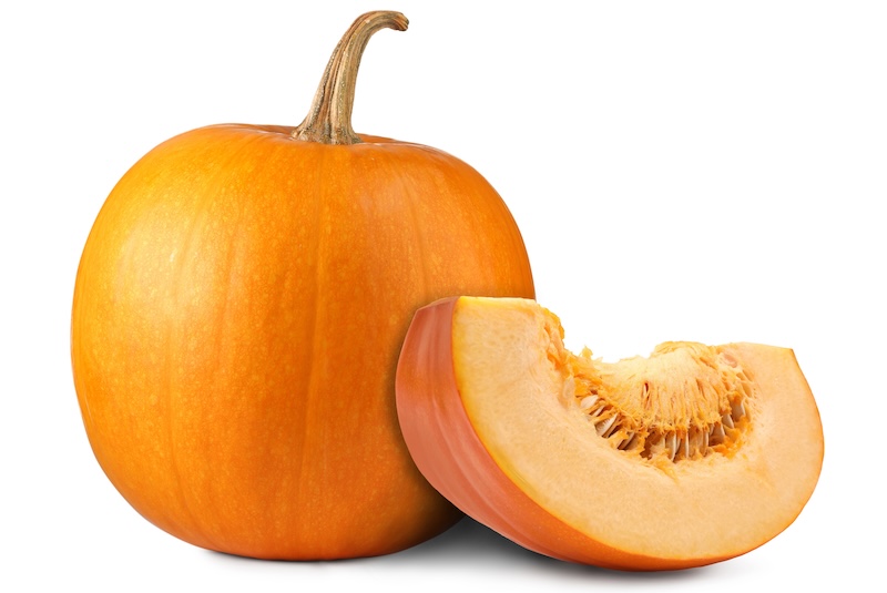Whole and cut fresh ripe pumpkins isolated on white