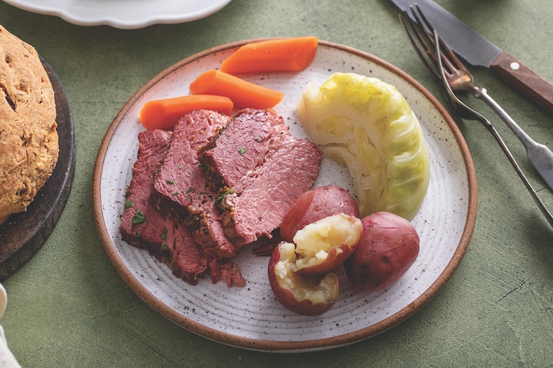 Corned beef sliced served with cabbage, potatoes and carrot, traditional Irish recipe for Saint Patricks day