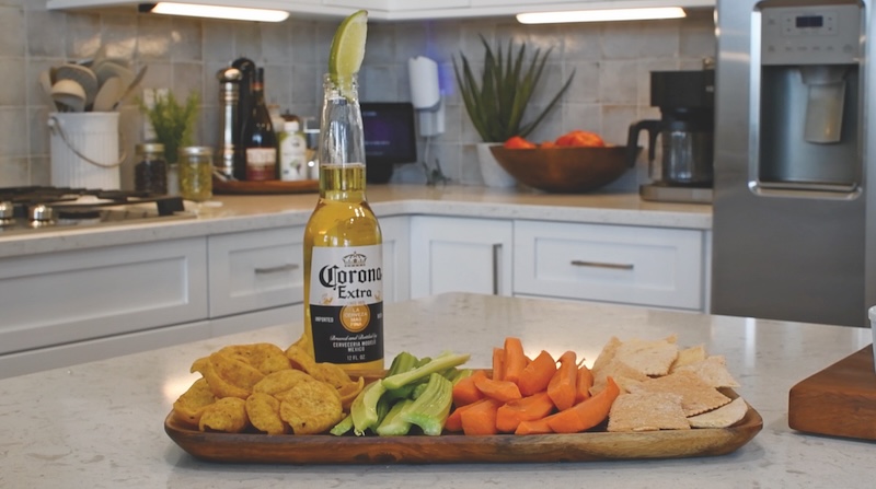 Beer, Buffalo Chicken Dip and lots of dipping snack options on a serving tray
