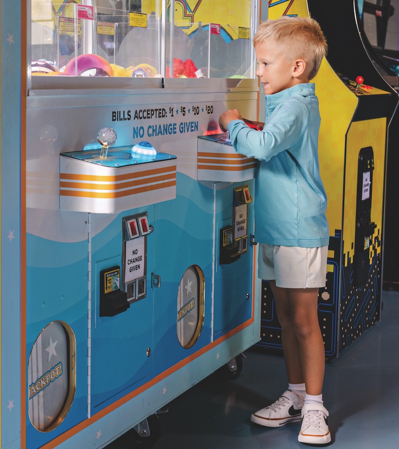 In a fun, candid moment at Local Legend Brewing, young local Deklan Ord shows off his game face, not for football, but for the claw machine.