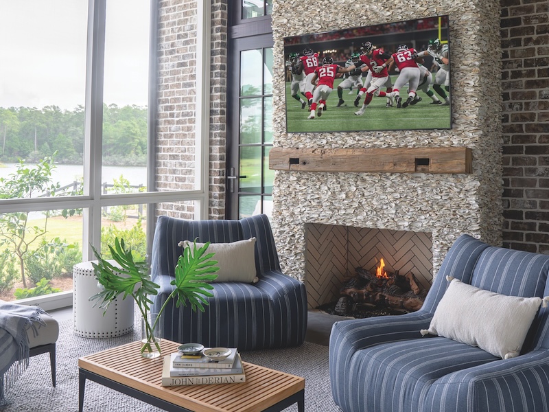 Entertaining set up in outdoor porch with fireplace and tv