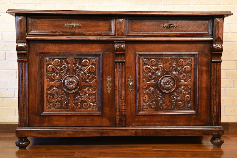 Antique dresser with delicate sculpture and craftsmanship
