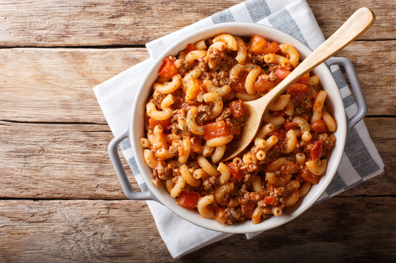 Family-style American goulash served in a baking dish, ready to enjo