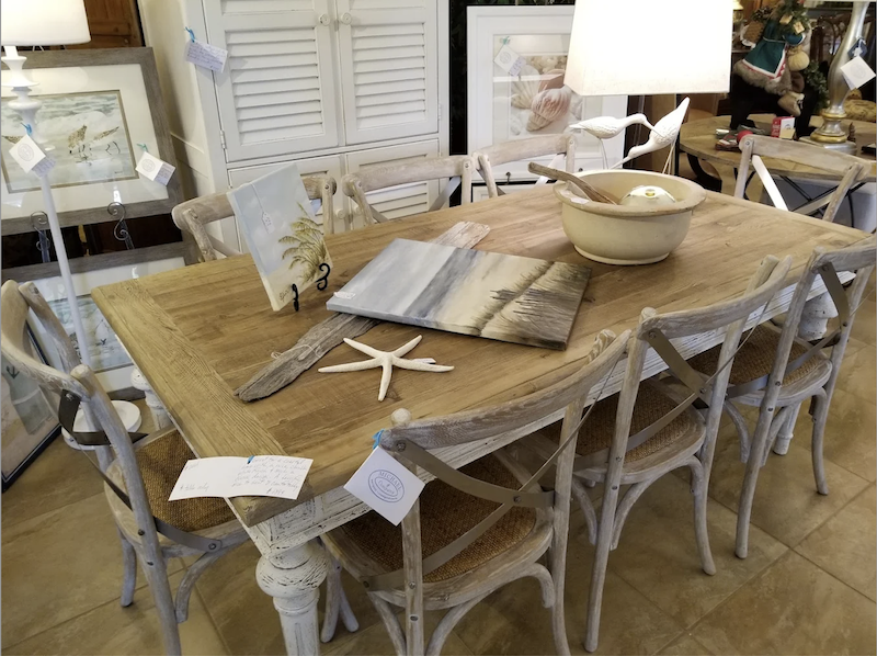 Michael & Co. Antiques on Hilton Head Island antique table  with coastal paintings, driftwood and seashell decor