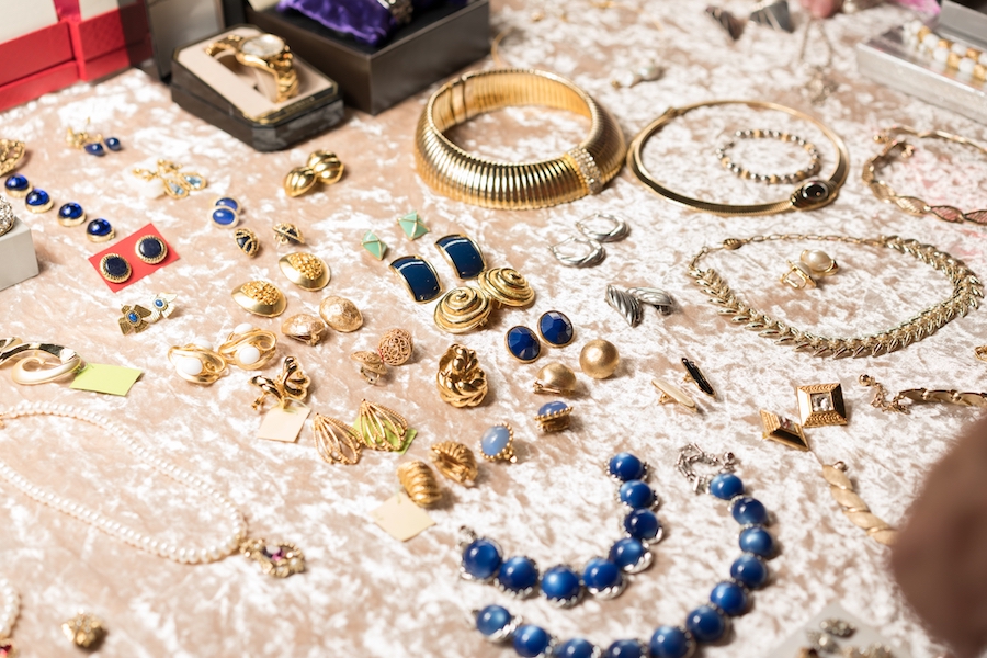 Retro style jewelry, antiques at flea market or garage sale - vintage jewelry, retro earrings, necklaces and other vintage things. Collectibles memorabilia concept. Selective focus