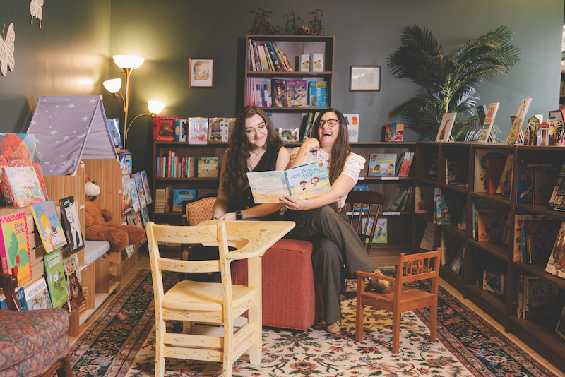 Rachel and Emily Baker, owners of Emry's Bookshop, read in their brick-and-mortar bookshop