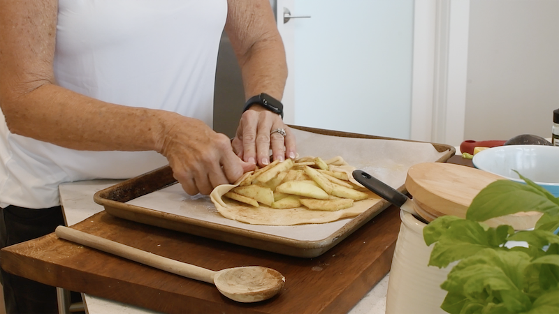 Folding a pie crust over a galette