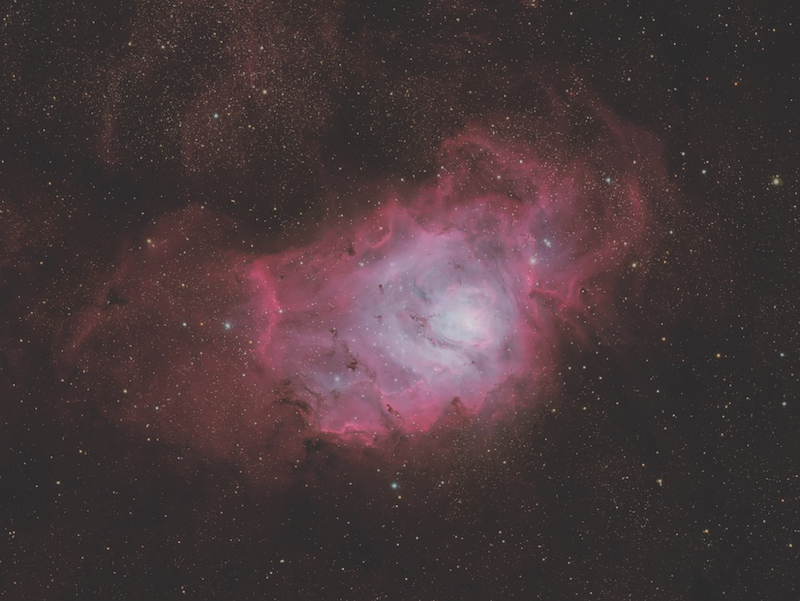 Lagoon Nebula purple pink cloud of gas and dust amongst stars