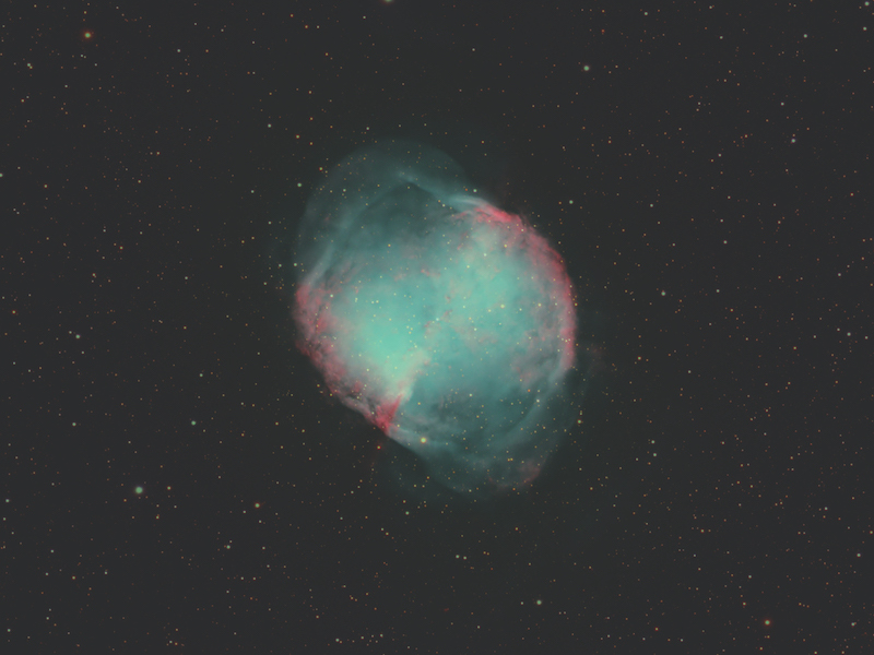The Dumbbell Nebula glowing teal and red shell of gas and dust