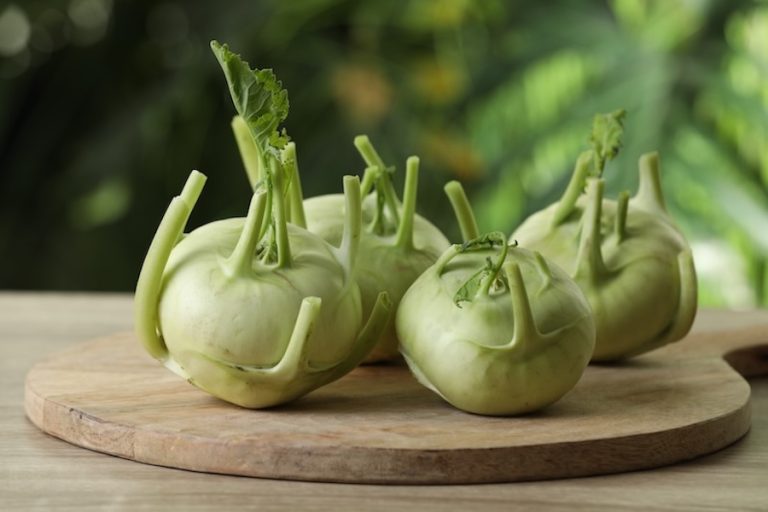 Whole ripe kohlrabi plants on wooden table