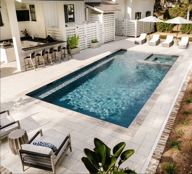 Pool and patio near outdoor bar and dining spring 2026 landscaping