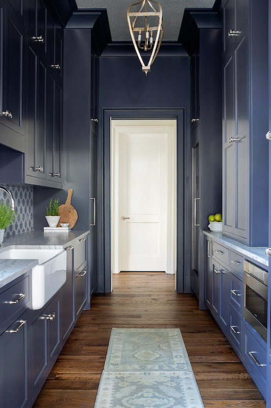 Second kitchen galley dark blue interior walls by Leah Bailey Interiors in Palmetto Bluff home