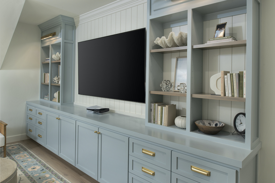 TV and shelf storage for games in Sea Pines entertainment room by RCH Construction