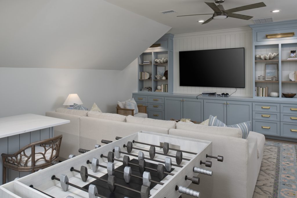 View of foosball table and TV in Sea Pines entertainment room by RCH Construction