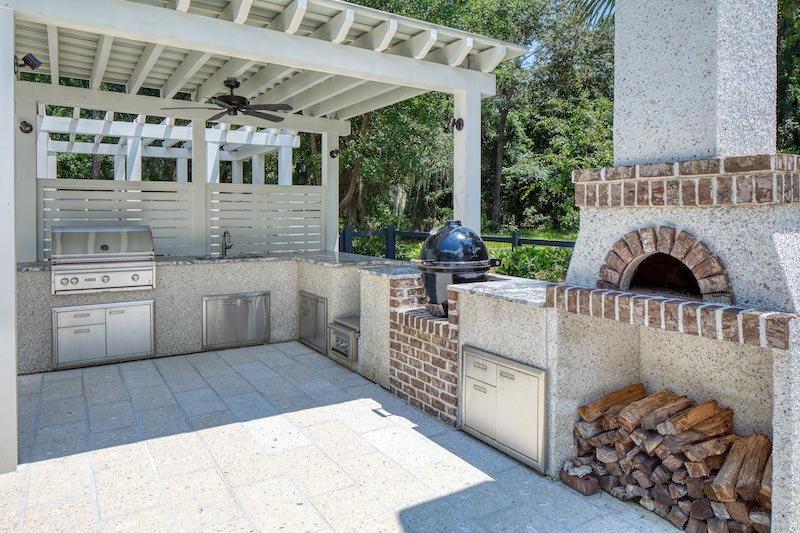 outdoor kitchen open-air entertaining stone oven and grill spring 2026 landscaping