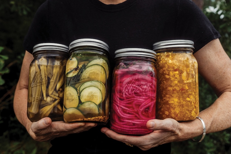 Jars of Pickled Okra, Honeyed Bread and Butter Pickles, Red Onions and Corn