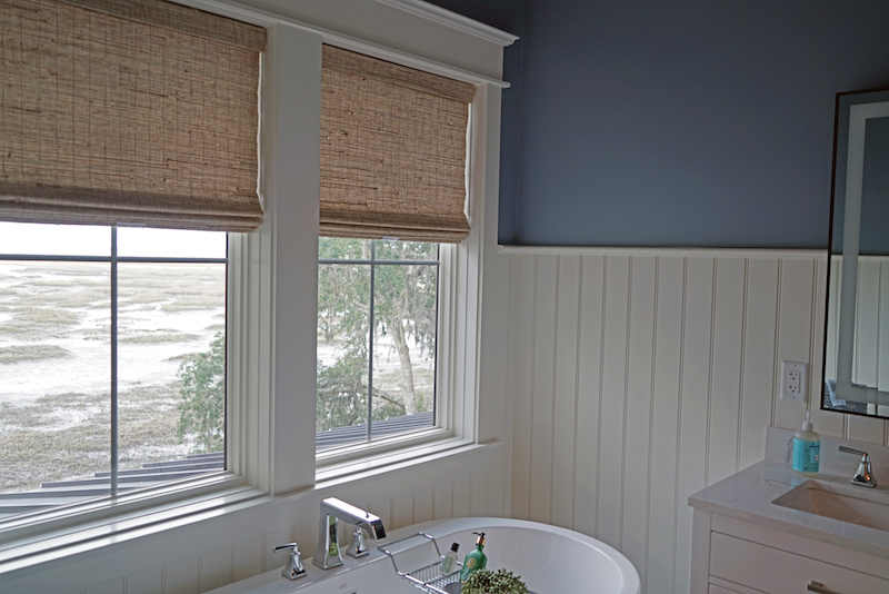 Belfair home with natural woven wood shades from Seaglass Windowscapes and Hunter Douglas in Bluffton home 2026 bathroom