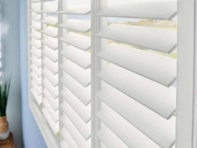 natural wood shutters Sea Pines home office by Pyramids and Group 3 Designs coastal interior design