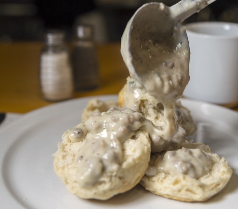 Sausage gravy poured over warm biscuits at Palmetto Bay Sunrise Cafe