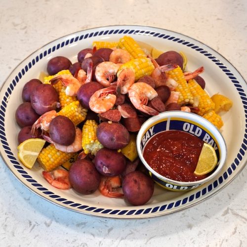 Lowcountry boil with shrimp sausage corn and potatoes served on platter