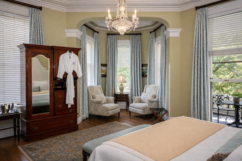 Luxury bedroom at Kehoe House with fireplace and traditional Southern furnishings