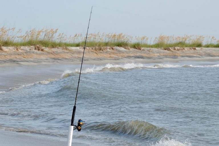 Fishing rod planted in surf on Hilton Head Island beach