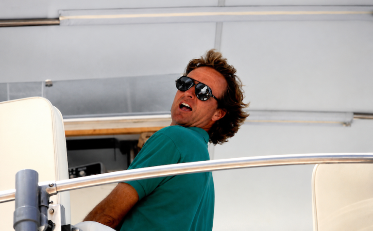 Salty Dog Cafe founder Bob Gossett fishing aboard boat in Hilton Head