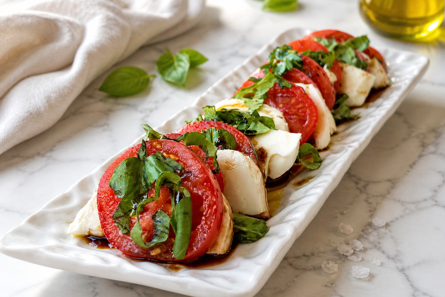 Tomato and mozzarella caprese salad served on platter