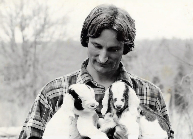 Young Bob Gossett holding goats on Spartanburg farm in 1977