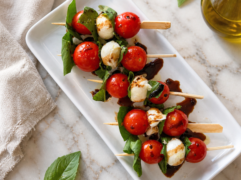 Caprese skewers with cherry tomatoes mozzarella and basil