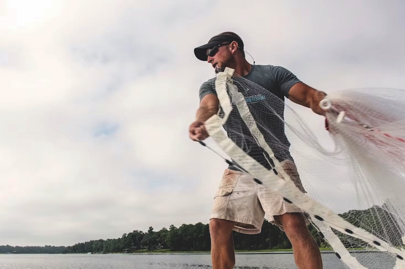 Fisherman casting net for shrimp in Lowcountry waters